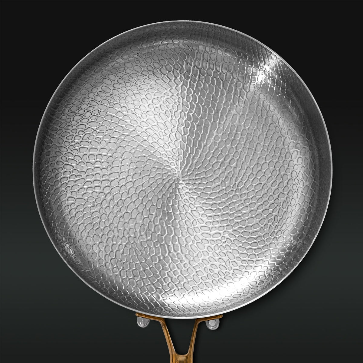 Hammered Titanium frying pan on a black background