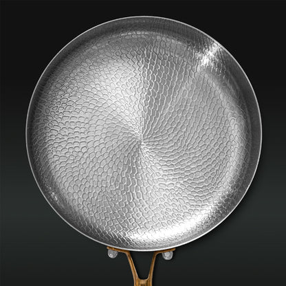 Hammered Titanium frying pan on a black background