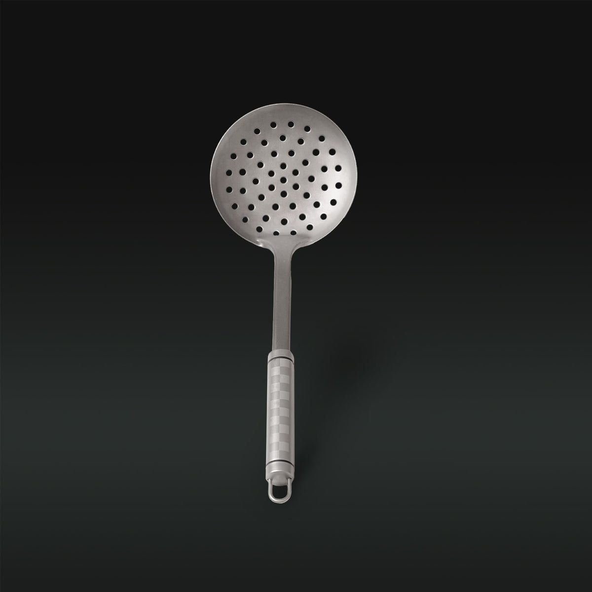 Metallic skimmer with holes on a black background