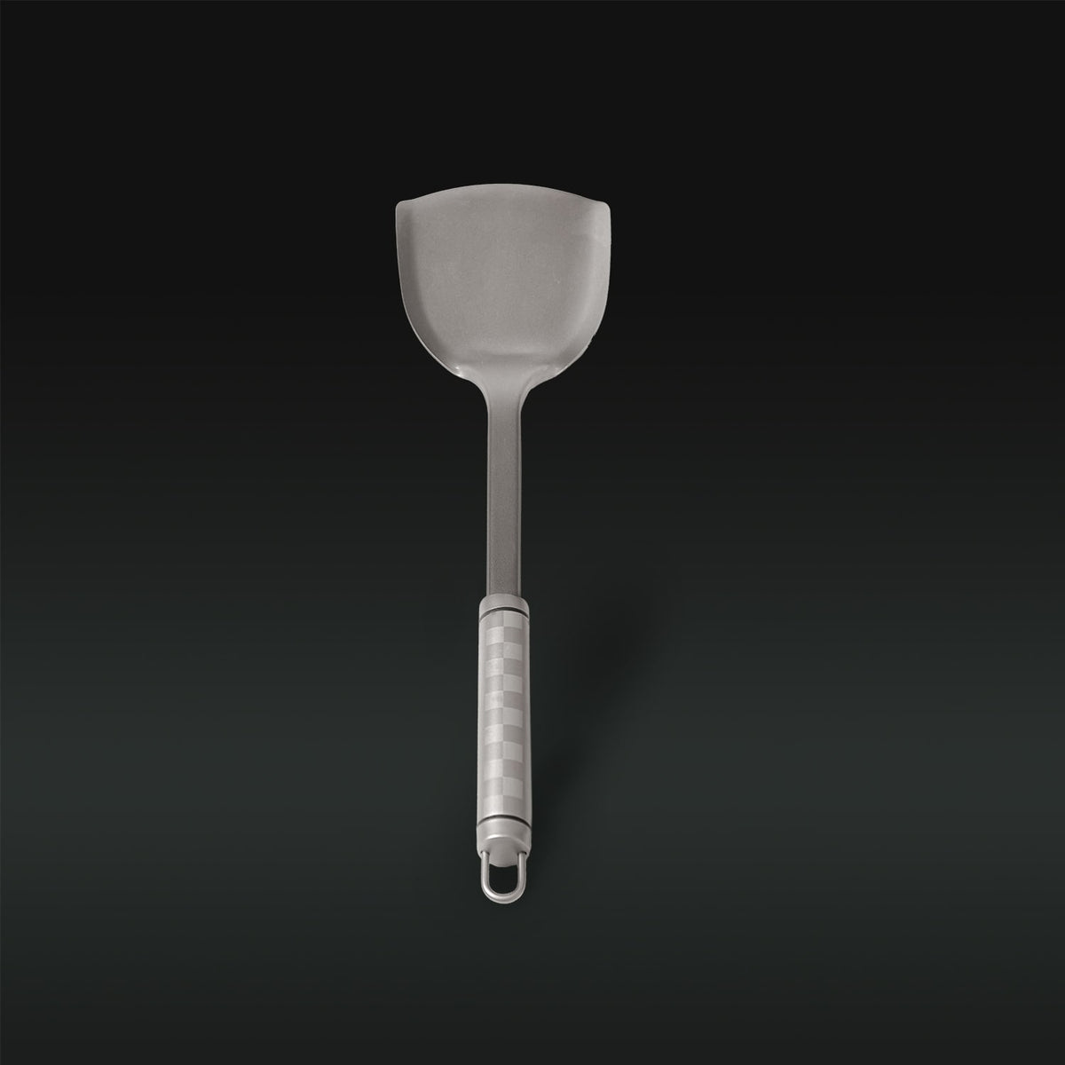 Gray slotted spatula on a black background