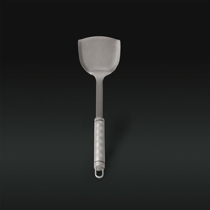 Gray slotted spatula on a black background