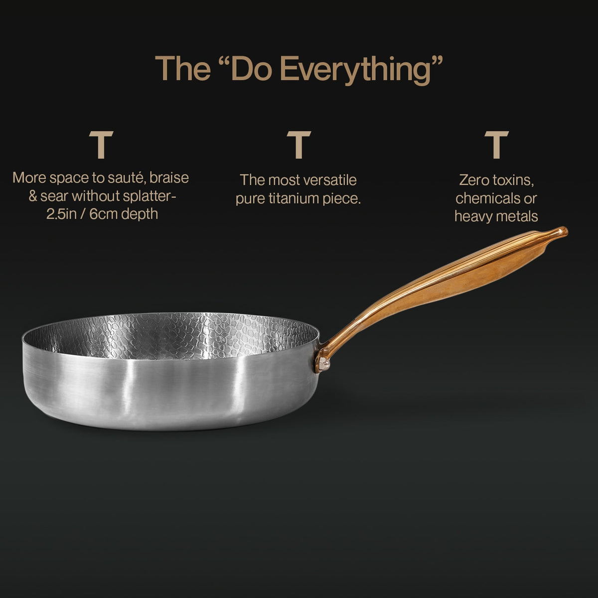 Titanium frying pan with golden handle on a black background