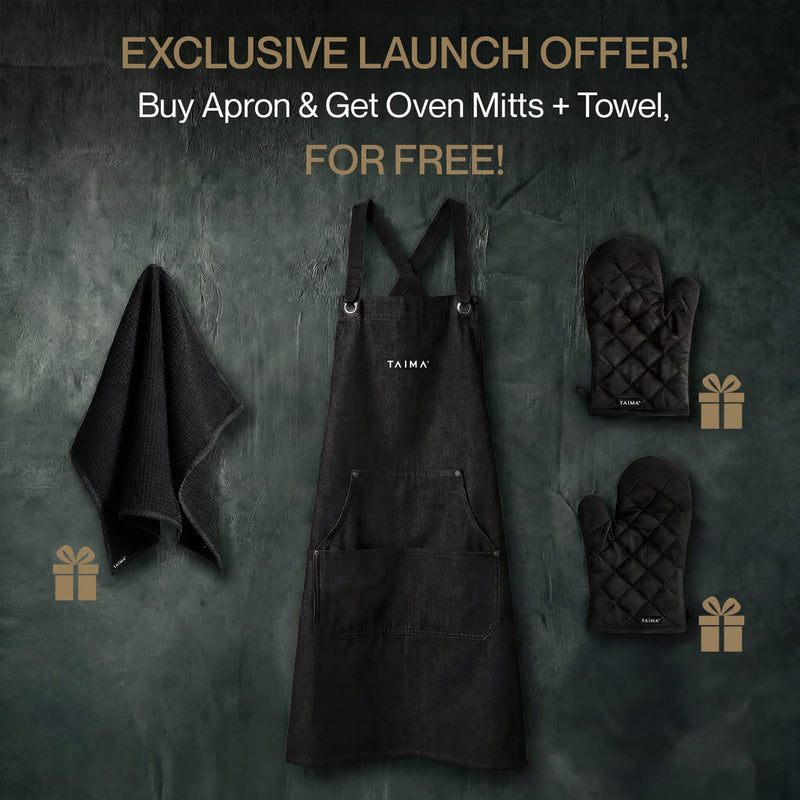 Black apron with oven mitts and towel on a dark background, featuring TAIMA branding.