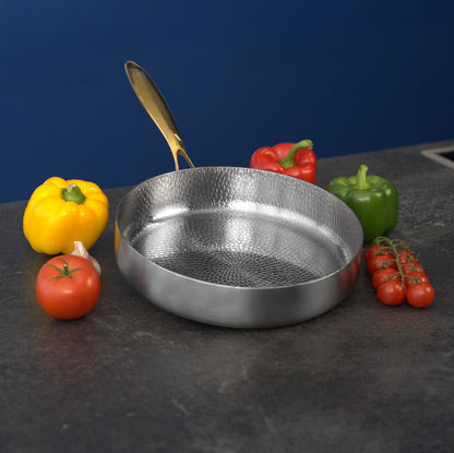 Titanium frying pan on a dark surface