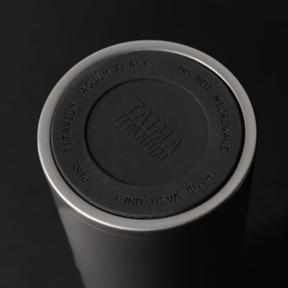 Tumbler with Titanium Vacuum Flask lid on a black background