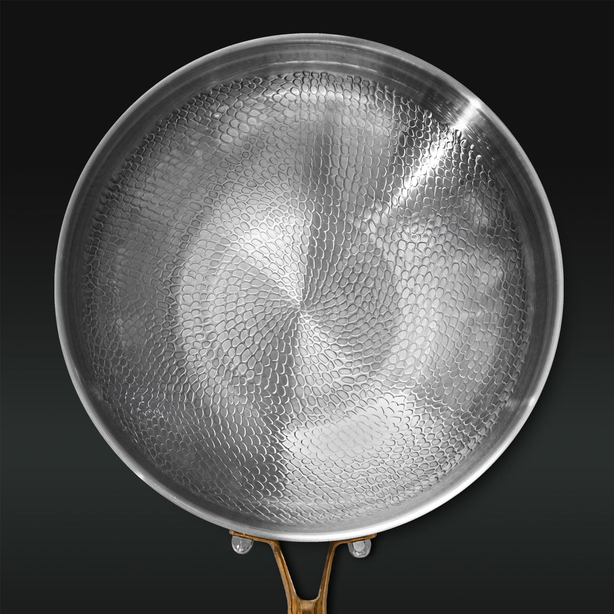 Titanium pan with textured surface on a black background