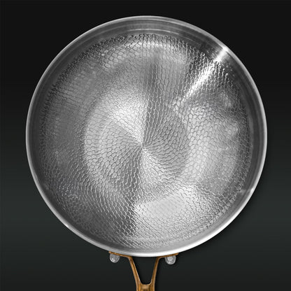 Titanium pan with textured surface on a black background