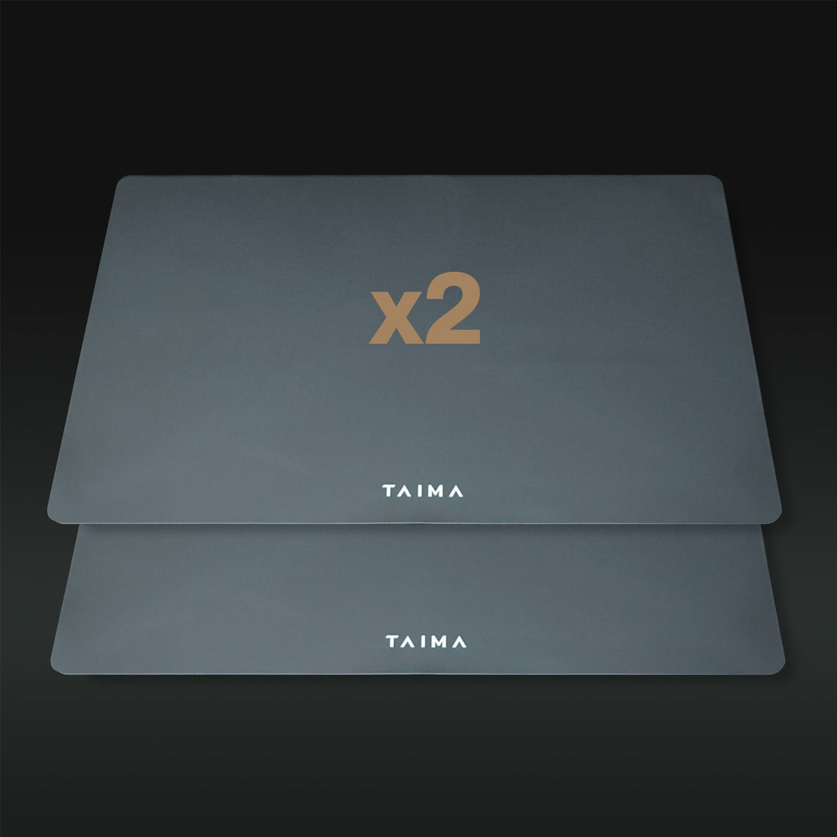 Two gray placemats with 'x2' and 'TAIMA' branding on a dark background
