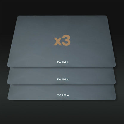 Three gray placemats with 'x3' and 'TAIMA' branding on a dark background